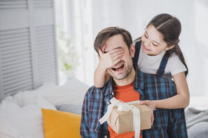 fathers-day-concept-with-daughter-covering-fathers-eyes