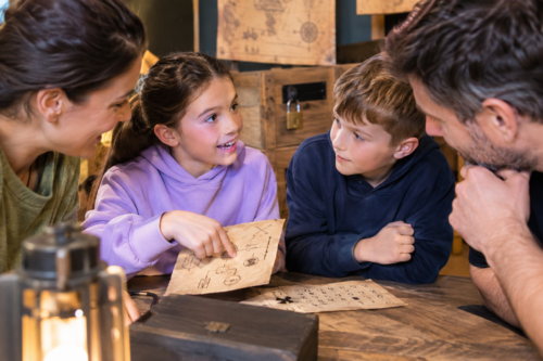 family working together to solve an escape room puzzle